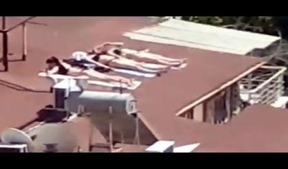 Sahile gidemeyince çatıda bikinili ve mayolu böyle güneşlendiler